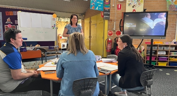Some of our staff sit together and work on Professional Development in the library.